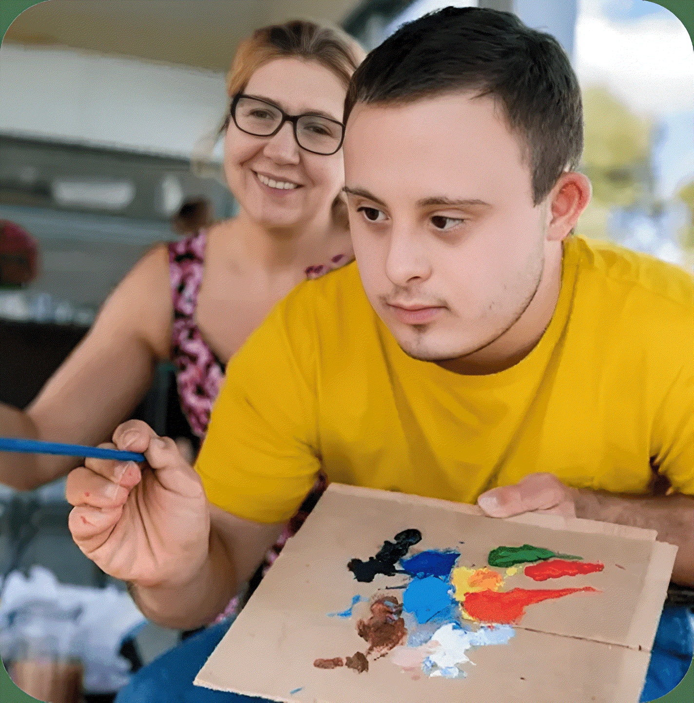 Person painting with assistance from another person.