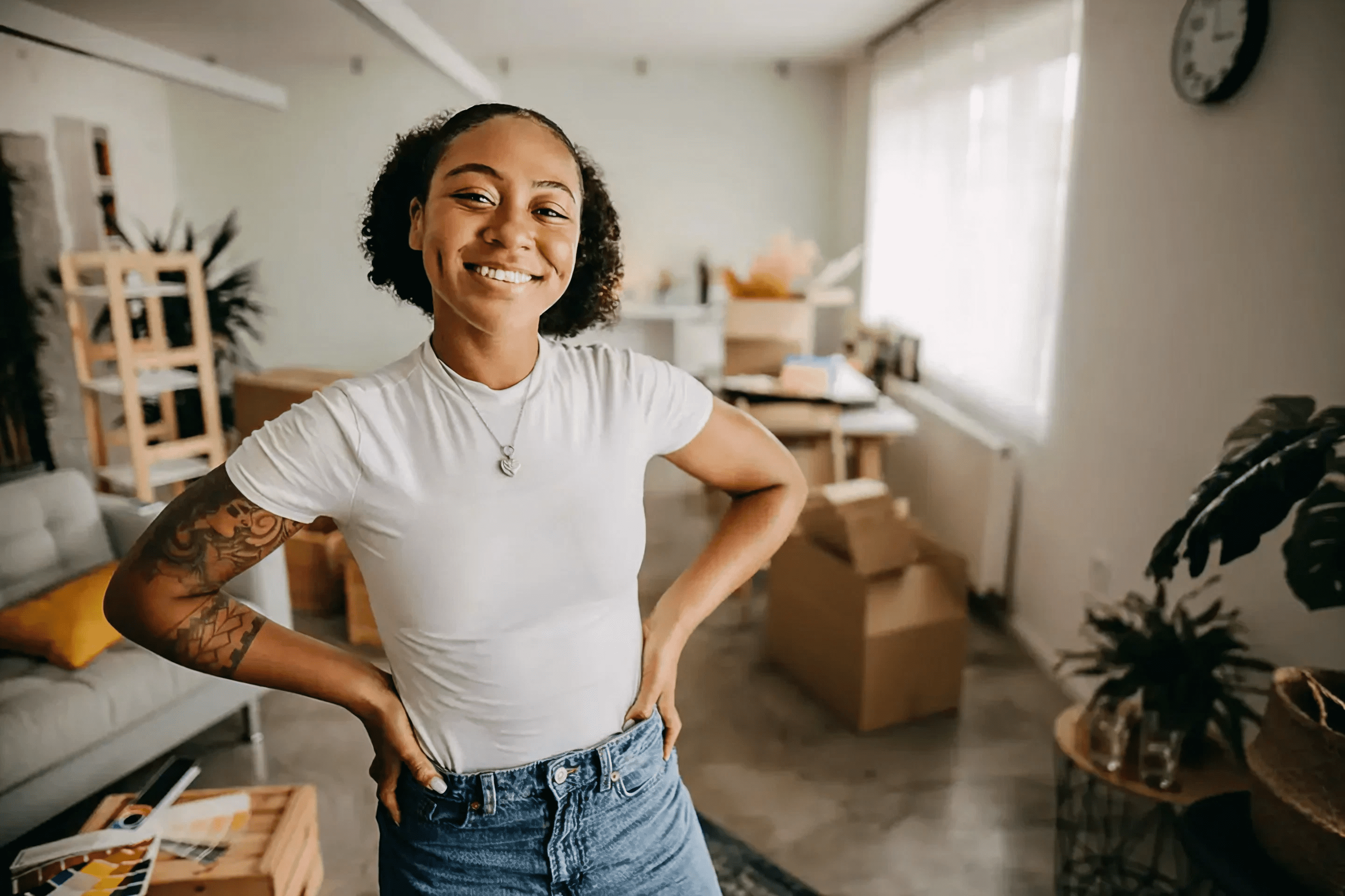 Smiling person standing in a cozy room.